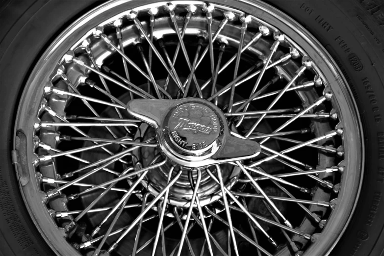 close up view of chrome spokes and tires on a black car