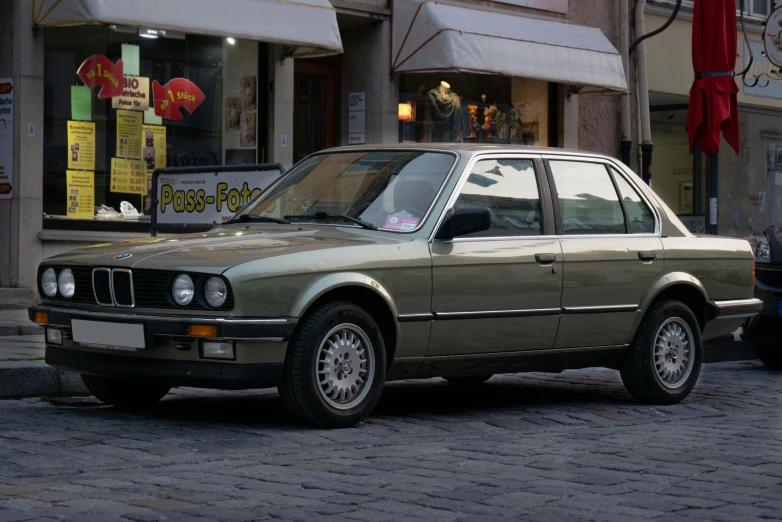 a bmw sitting on the side of the road