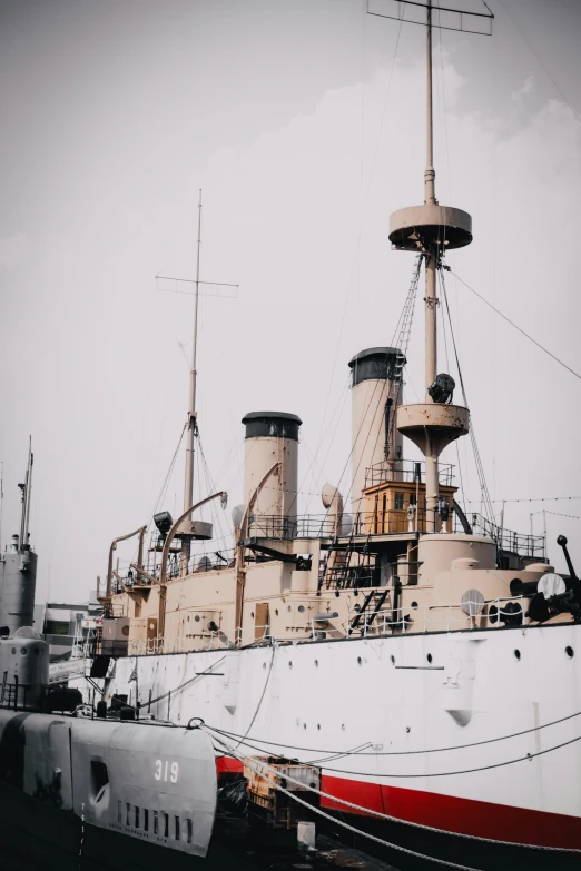 a large, white boat sits docked next to a smaller ship