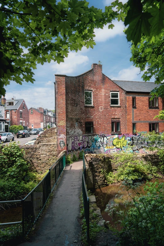 there is graffiti on the side of a red brick building