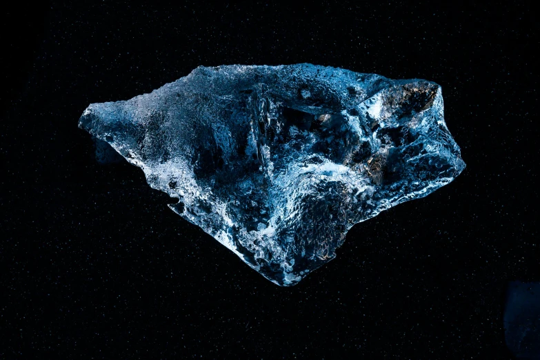 a rock sitting on top of a dark floor