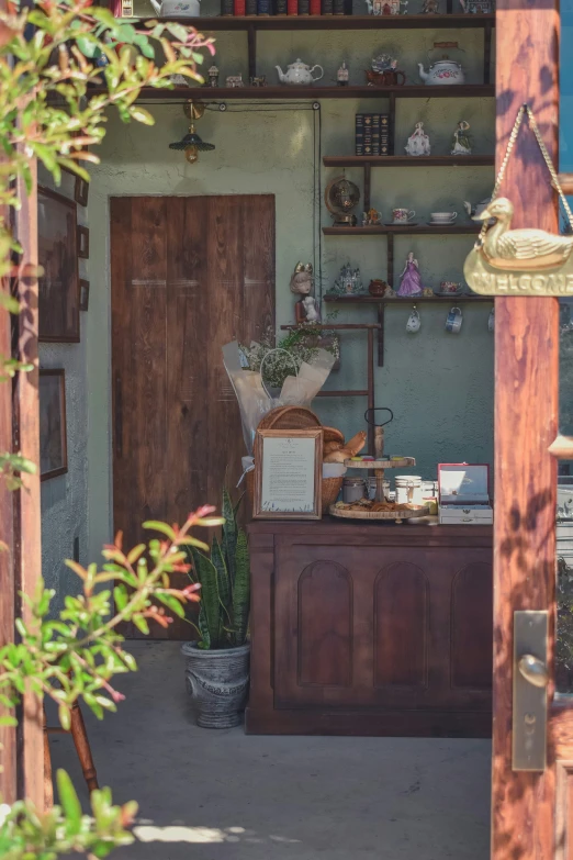 a store with an open door that has wooden shelves and pots on top of it