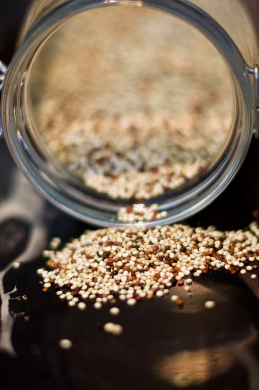 an open glass jar with seeds inside of it