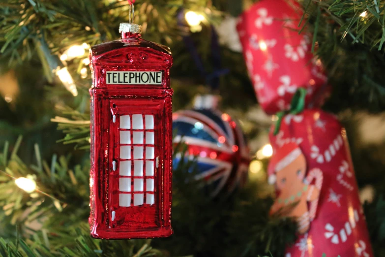 the telephone booth ornament is hung from the tree