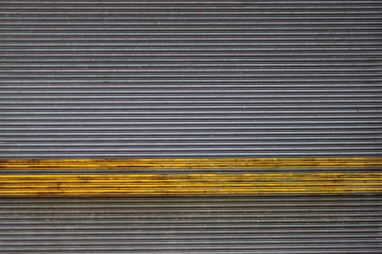 a yellow bench with black stripes on it