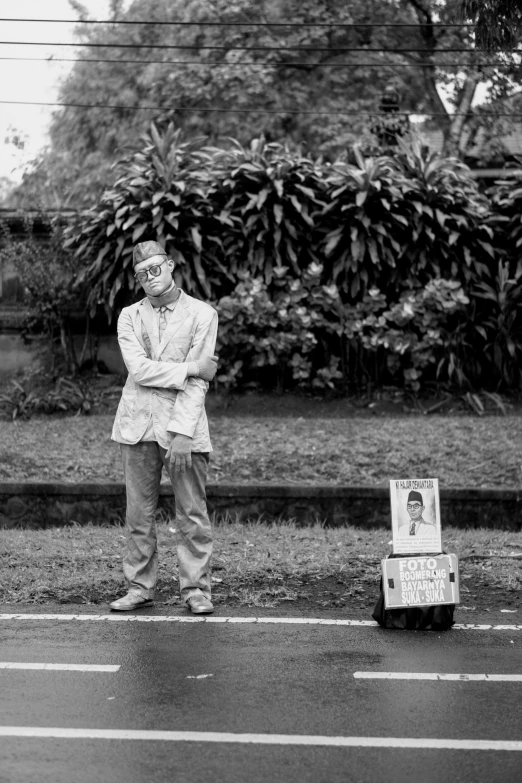 the man in the suit stands in front of his mailbox