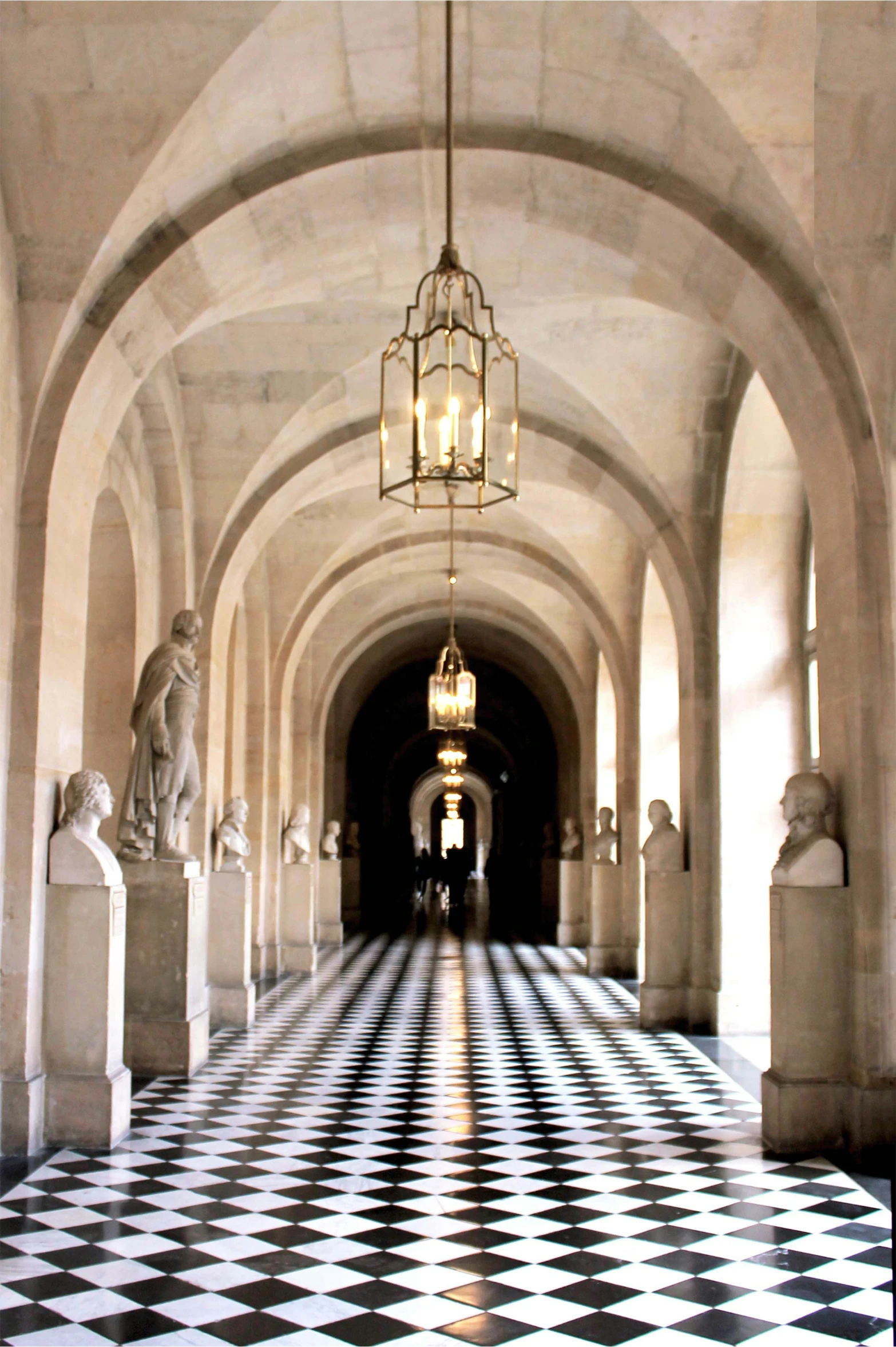 a large hallway with intricate marble decor and pillars