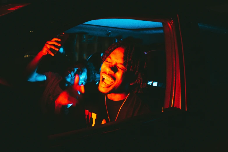 a young man driving his car at night