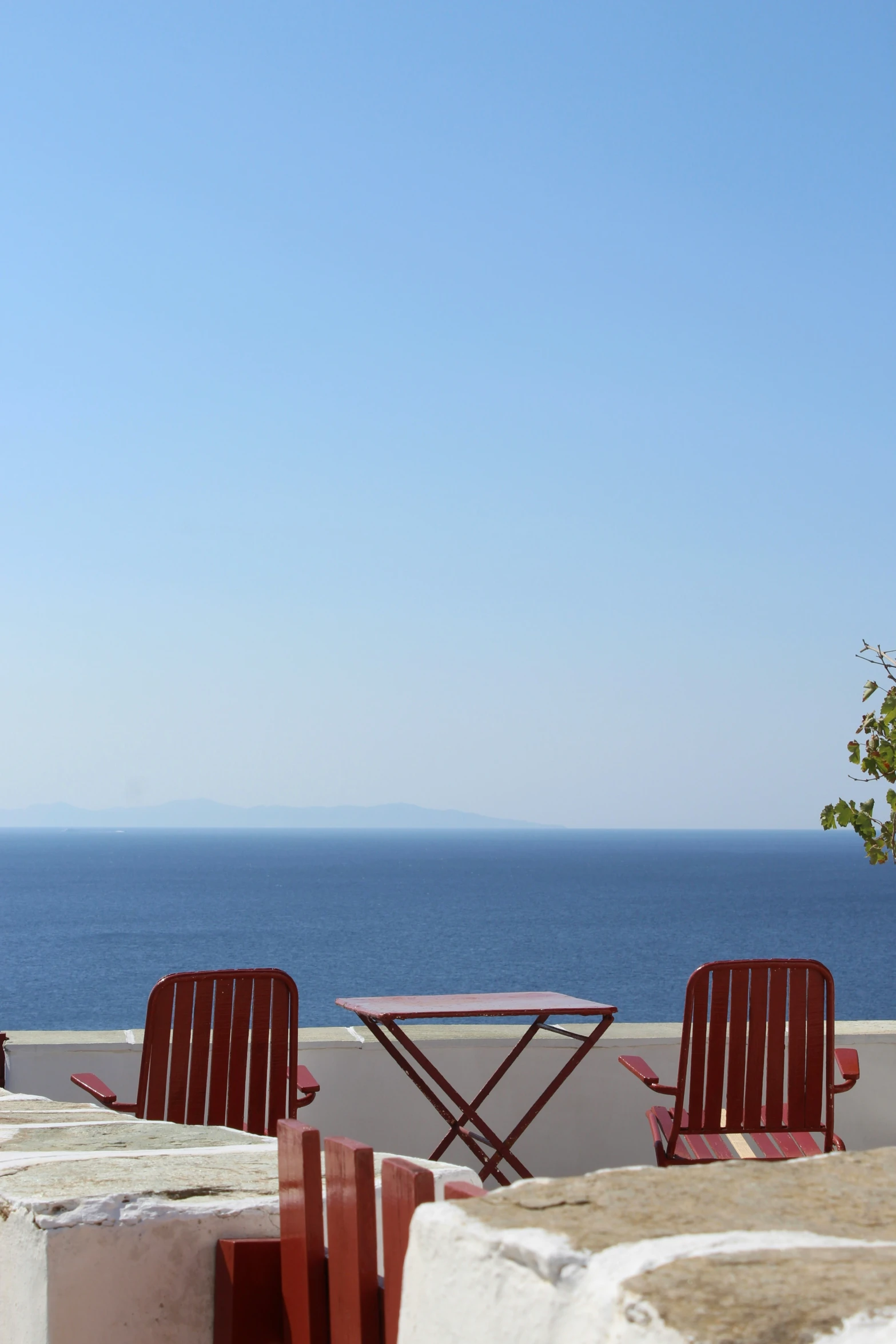 a couple of chairs and a table on a balcony