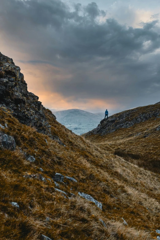 a person standing on top of a rocky mountain