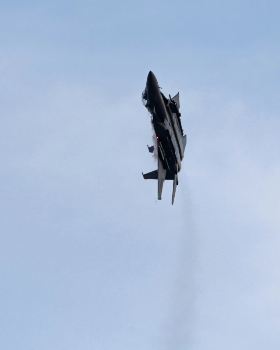 a fighter jet in the air on a sunny day