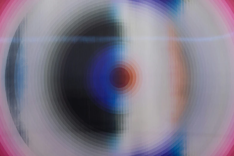 an image of a colored circular pattern that looks like it has been distorted and is very blur