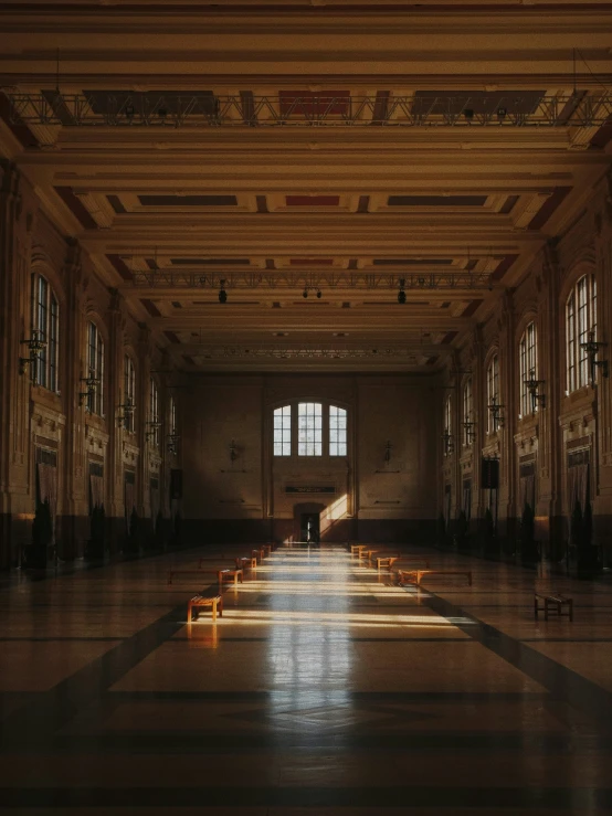 a dark room with benches and windows in it