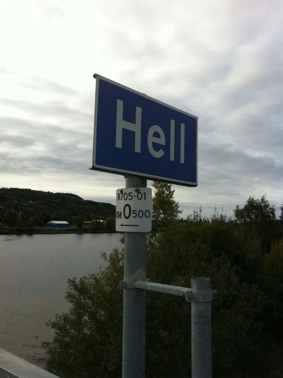 a street sign that reads hell in english and white