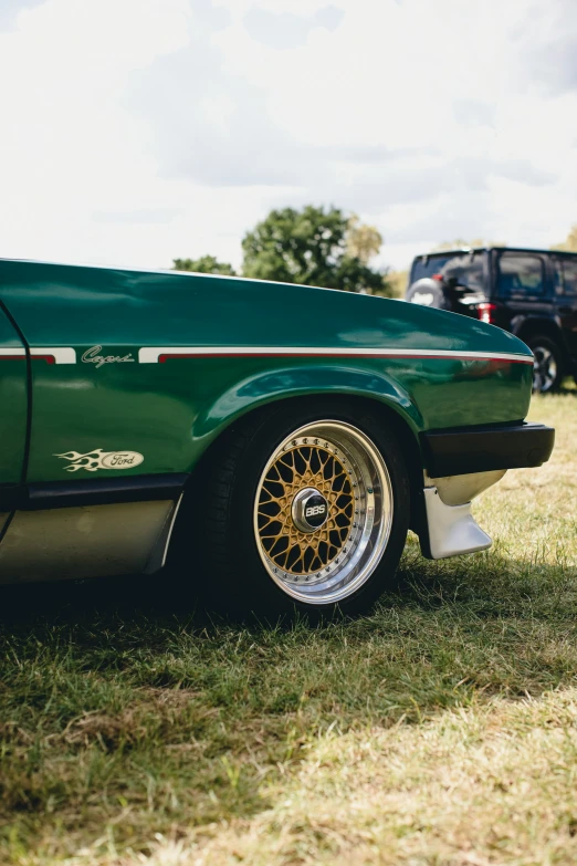 a green car is parked in the grass