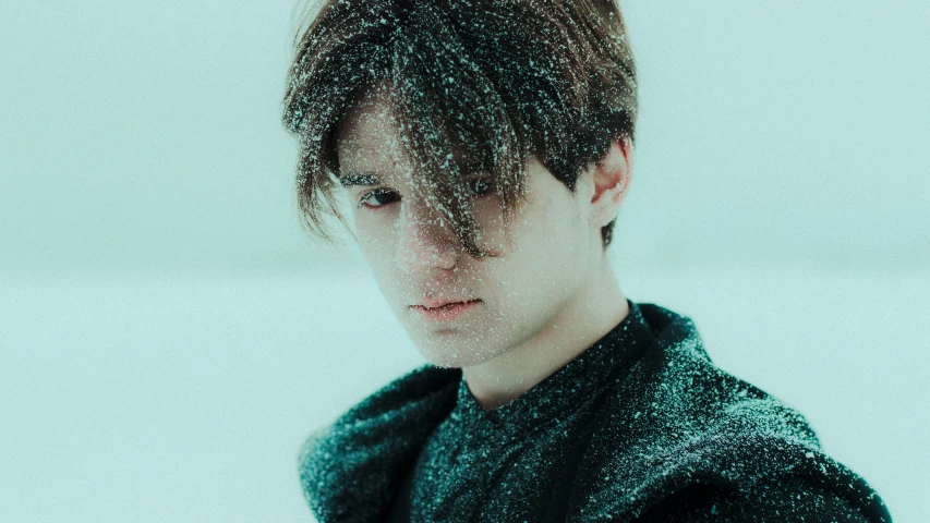 a young man wearing black stands with his head tilted back