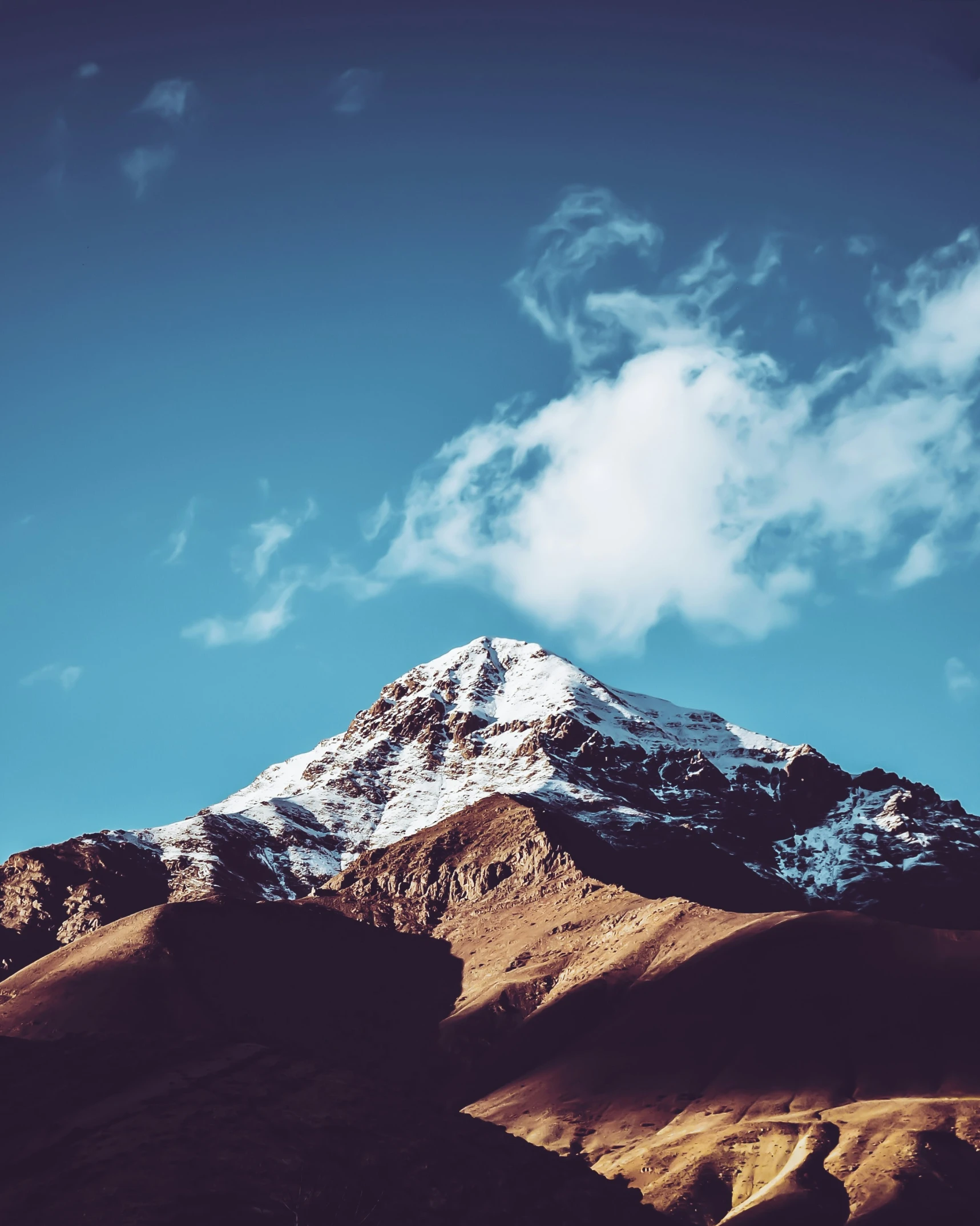 a large snow capped mountain on the horizon