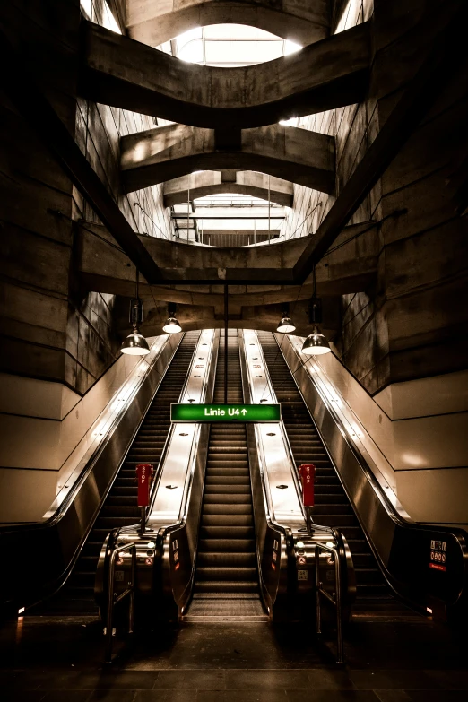 an overhang view of escalators in a station