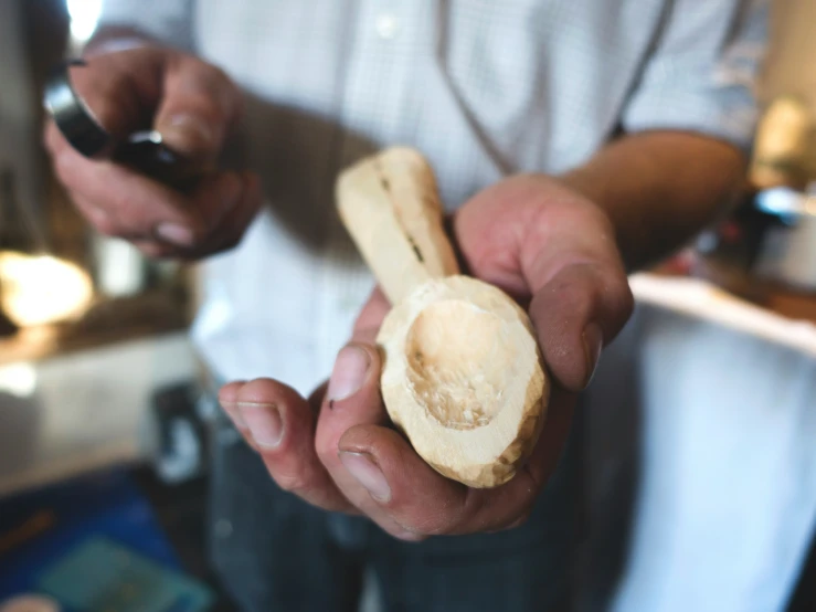 a person holding a peeled piece of bread in their hands