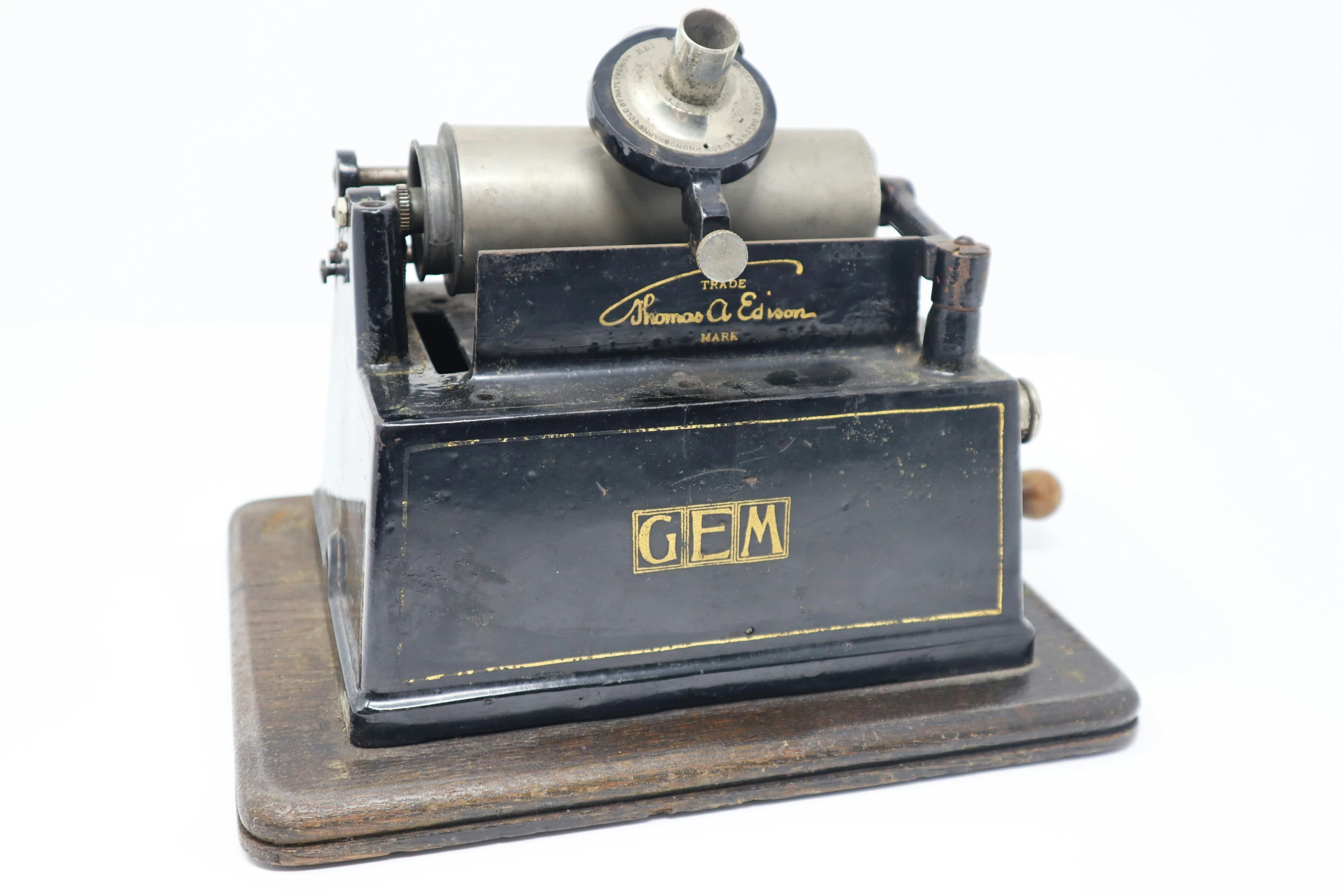 a toy steam engine sits on top of a small metal base