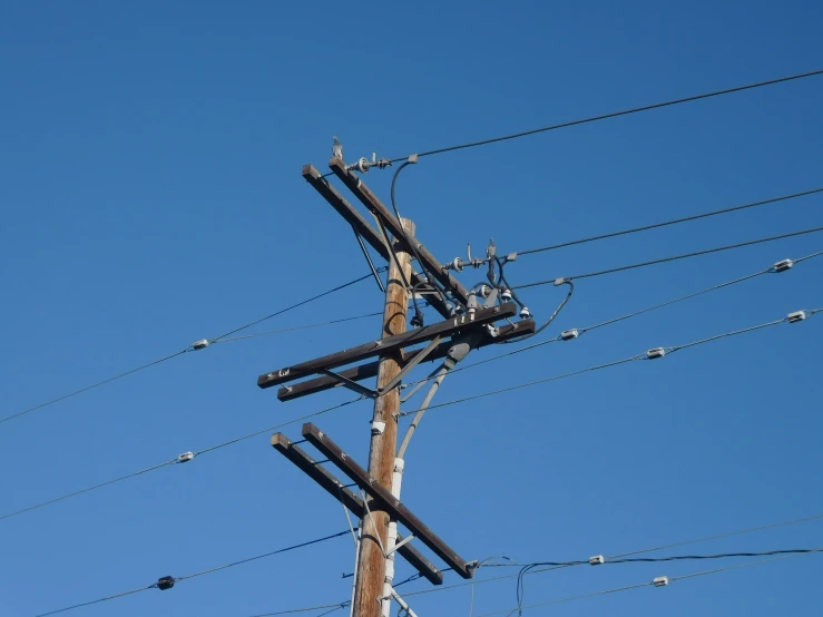 the pole has multiple electrical wires attached