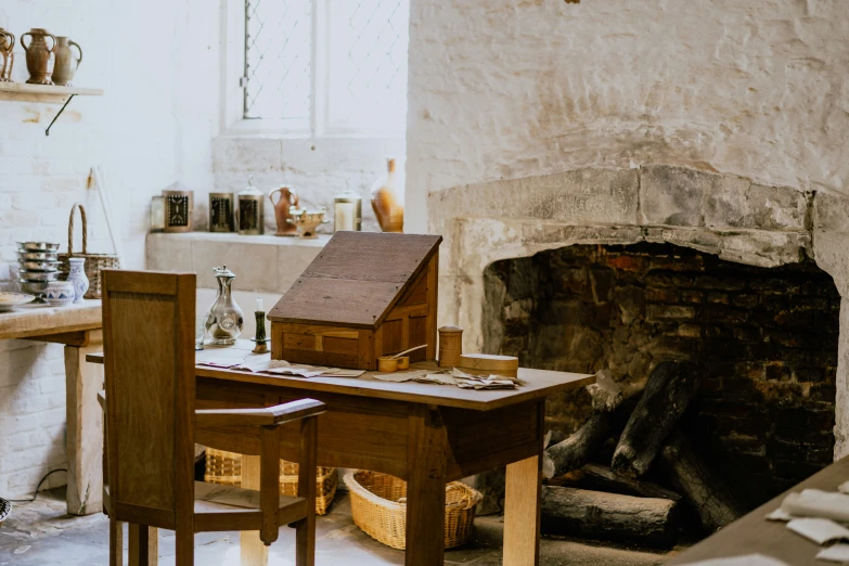 a wooden table with a desk in front of a fireplace