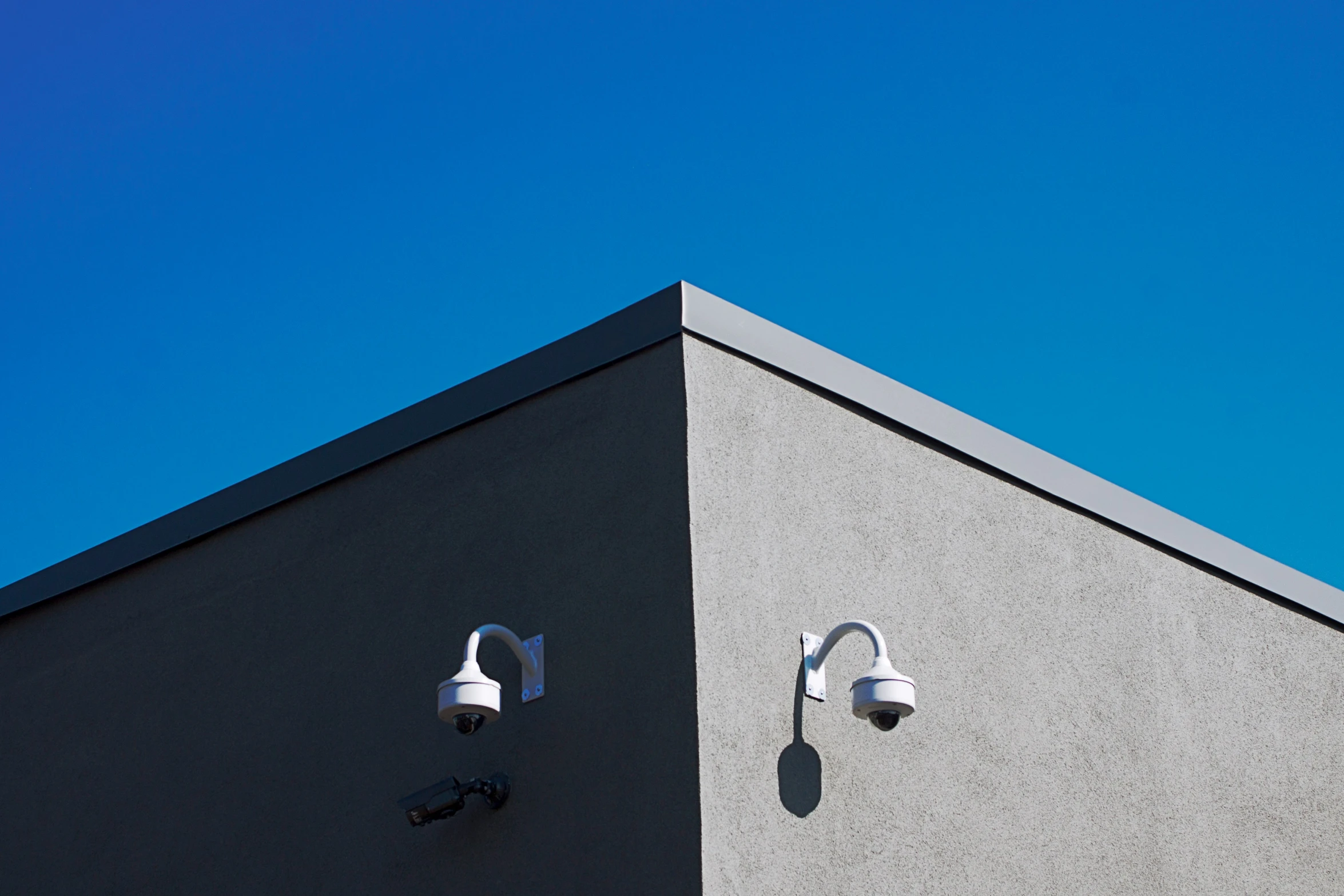 the two lights on the wall near a building