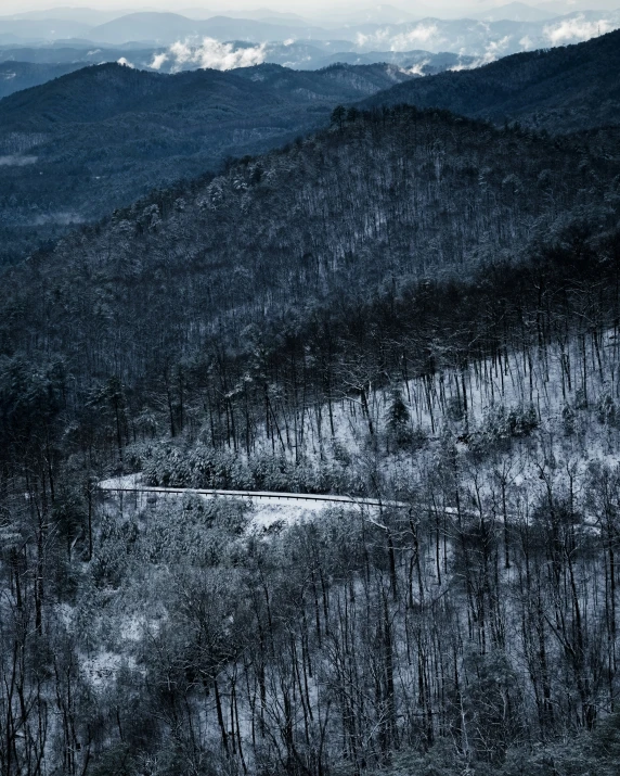 black and white pograph of mountains with snow on it