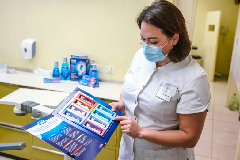 a female doctor is displaying her medical booklet