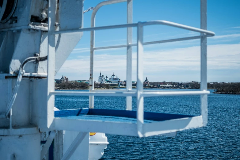 the view of water and buildings through a ship's front window