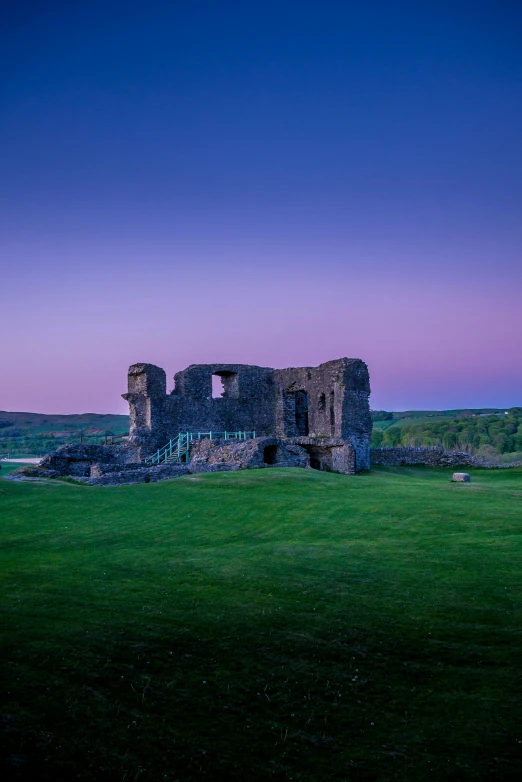 an old abandoned stone building in a field