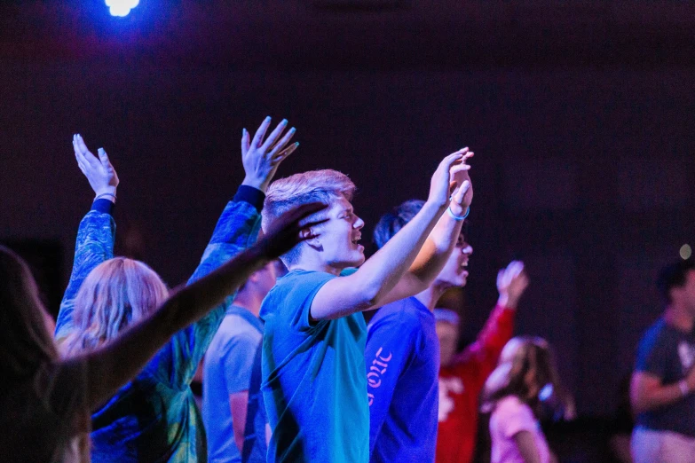 a group of people standing around each other in front of a crowd