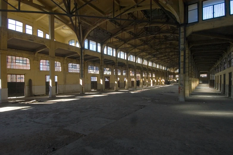 a train station with several rows of windows and benches