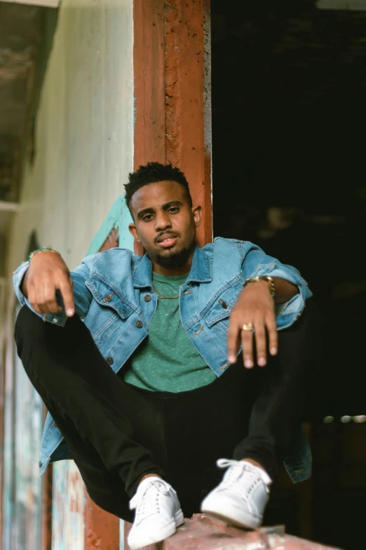 a man posing on a ledge for the camera