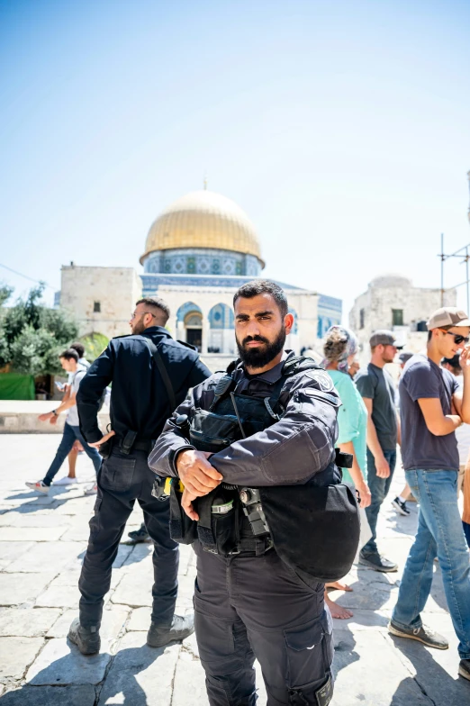 a man wearing a backpack is posing for a picture