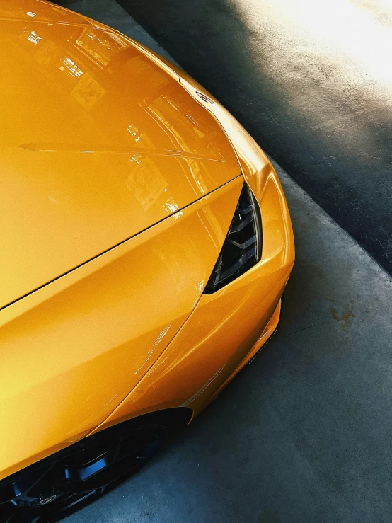 a close up of a shiny orange sports car