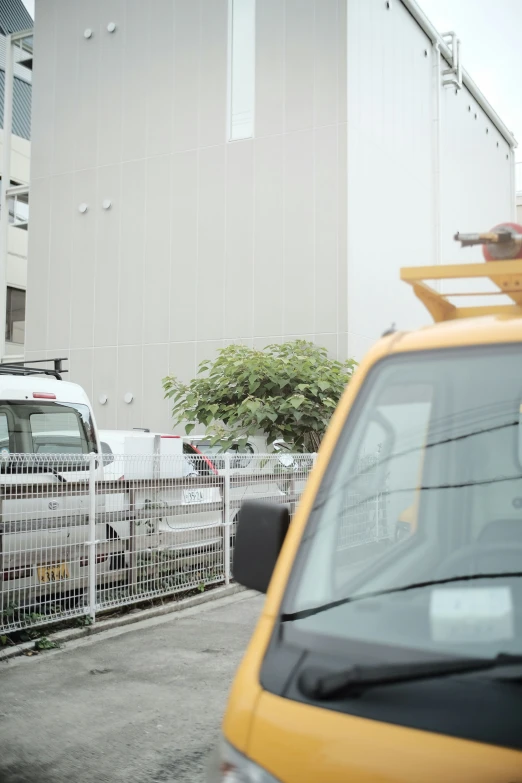 a yellow truck parked on the side of a street