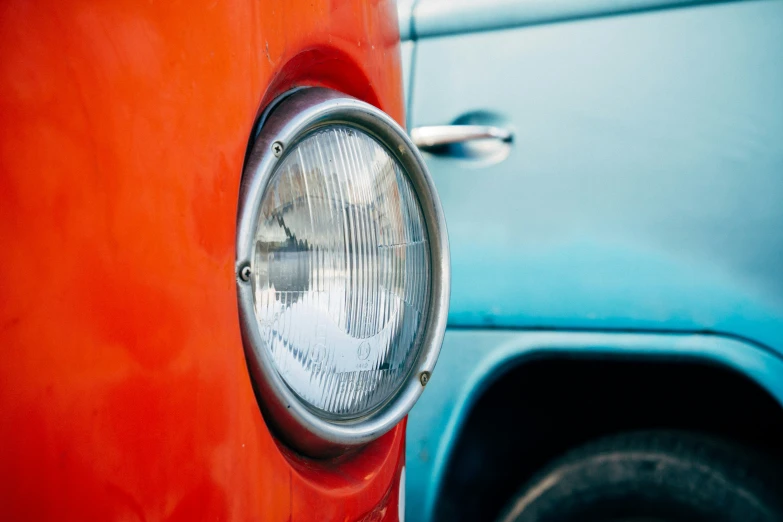 the headlight of an old car is seen