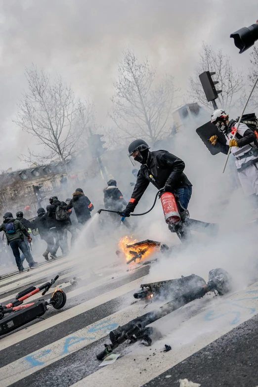 people on a road surrounded by police