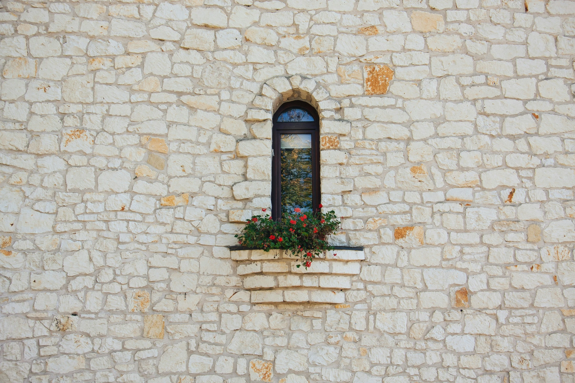 a window with a flower box at the top of it