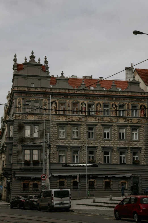 a red car is parked outside of an old building