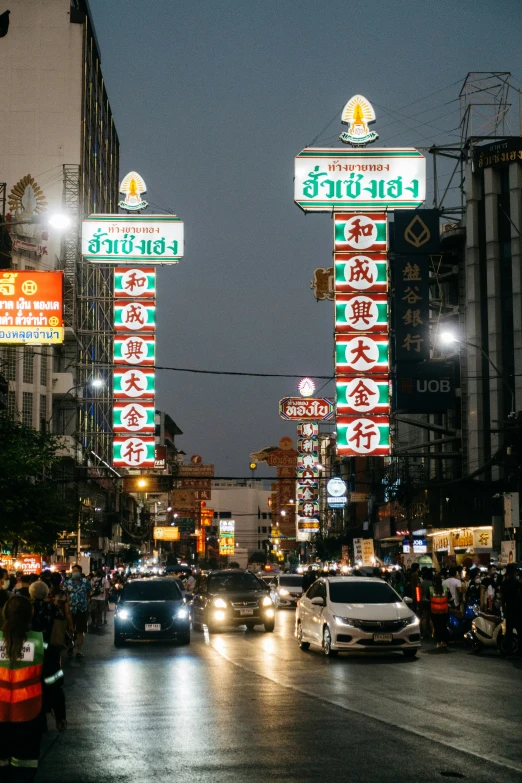 a lot of signs on a street near traffic lights