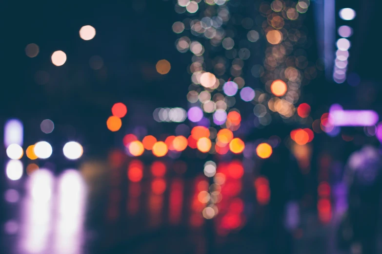 a city street with lights and blurry buildings