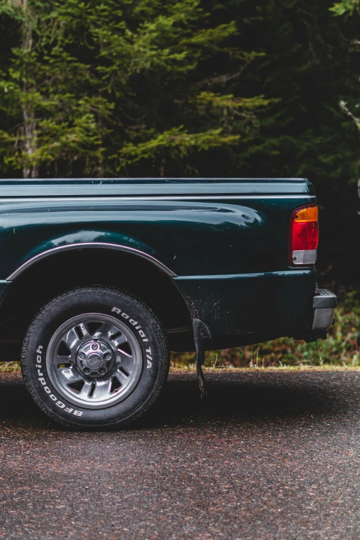 a truck parked in front of some trees