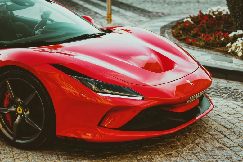 red sports car parked in the city with lots of traffic