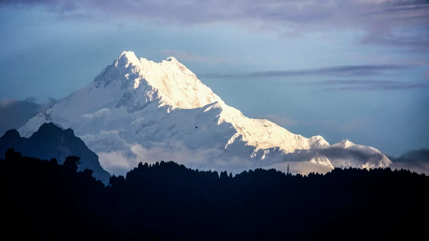 a snow covered mountain range rises in the background