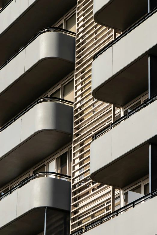 there is a tall building with balcony windows