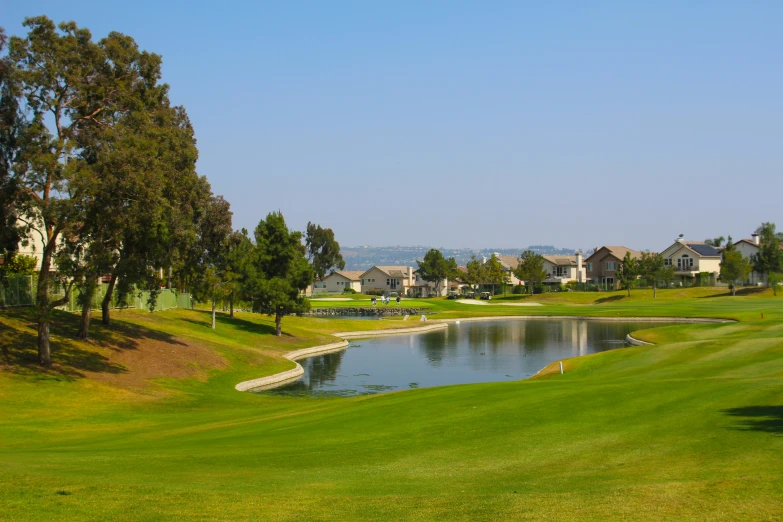 the golf course at the edge of a pond