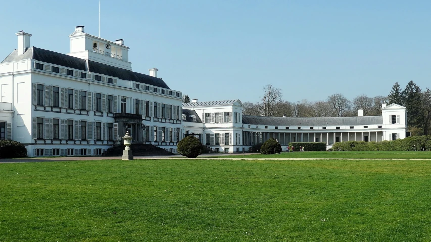 an elaborate white building on top of a lush green hillside