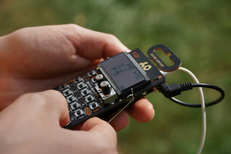 a person holding a remote control with wires attached to it